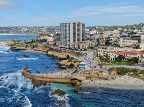 Aerial view of La Jolla coast, San Diego, California. Beach and blue sea with small waves. Hilly seaside of curving coastline along the Pacific.