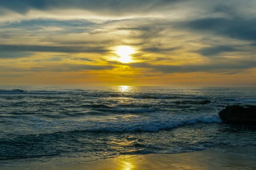 Beautiful colorful sunset over the sea, clouded sky on twilight time and reflection on the sea. in La Jolla, San Diego, California, USA