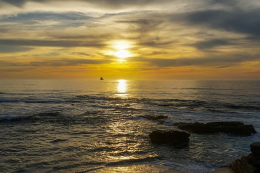 Beautiful colorful sunset over the sea, clouded sky on twilight time and reflection on the sea. in La Jolla, San Diego, California, USA