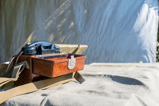 old military wired phone stands on the table in the army tent