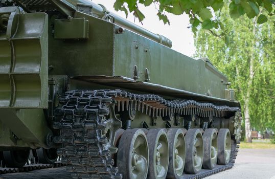 military tracked artillery howitzer stands on the alley in the Park