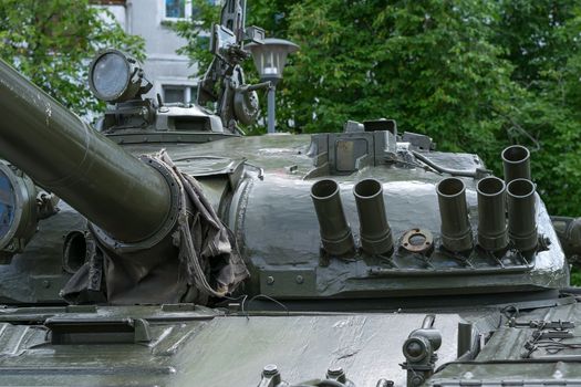 close-up view of the military tank tower on the background of a residential building