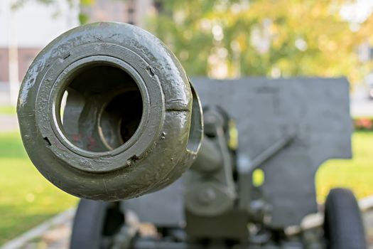 a sample of a military cannon close-up on the background of a residential area