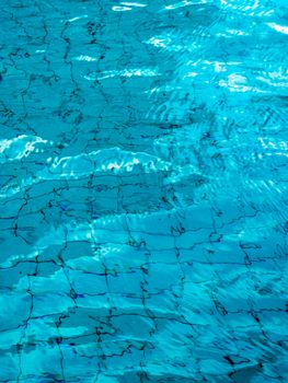 Reflection of sky on the moving water surface in the pool