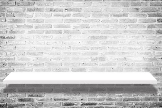 empty white shop shelf with shadow , retail shelf on brick vintage wall room background. white shelf isolated on brick background. shelf mockup