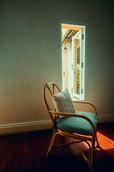 relaxing on free time day at home. vintage chair near window with warm light for relax on weekend or holiday
