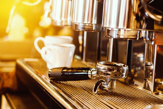 coffee machine. coffee machine preparing fresh coffee into white coffee cups at restaurant, bar or coffee shop. warm light effect