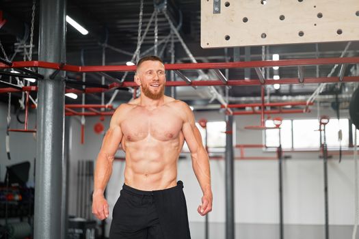 Man climbing pegboard gym athlete training arm strength stamina alpinism indoor. Athlete caucasian guy standing background wooden campus board warming up to climb Functional Cross training workout