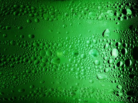 abstract background : bubble of sparkling water soda on the green glass bottle with gradient light