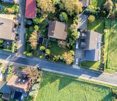 Aerial photo with the drone, anew build-up plot with single houses and gardens, narrow neighborhood