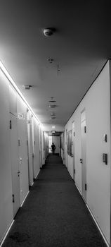 Long corridor in an administration building, central perspective, black and white