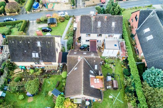 Aerial photo with the drone, anew build-up plot with single houses and gardens, narrow neighborhood