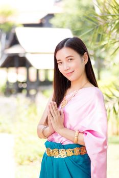 Asian beautiful woman wearing traditional Thai culture,vintage traditional dress suit style pay respect. Traditional Thai dress with identity Thai culture Sawasdee,Welcome expression Sawasdee
