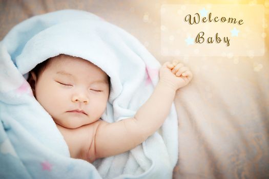 Colorful cute baby shower beautiful card with text welcome new baby in transparent frame, with the gold elements , star and wonderful bokeh in the morning light. film effect