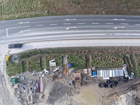 Aerial photograph of the material store for canal construction work on the construction site of a new development area, photographed with the drone