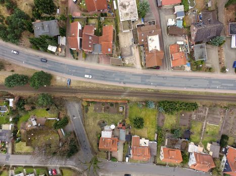 Aerial view of an old housing estate on the outskirts of the city with railway tracks close to the buildings, drones shot