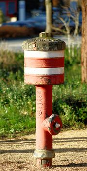 Fire-brigade hydrant with red and white stripes in Germany