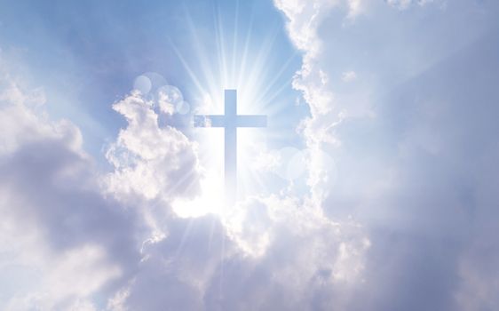 Christian cross appears bright in the sky background