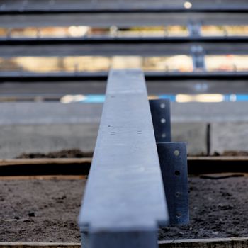 Steel girder on a construction site, with low depth of field directly from the front, central perspective, abstract