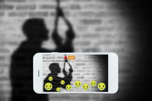 Problem of using social networks with wrong purpose effect concept:silhouette of sad man hanging suicide stream his commits suicide stream live on social media. Crime ,violence within social networks.