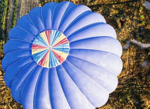 View from above onto a blue balloon shortly before landing in Cappadocia, Anatolia, Turkey, taken from the hot-air balloon