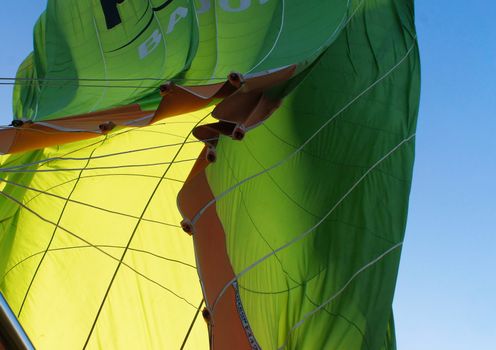 View from below onto the collapsing envelope of a green hot-air balloon, Cappadocia, Anatolia, Turkey