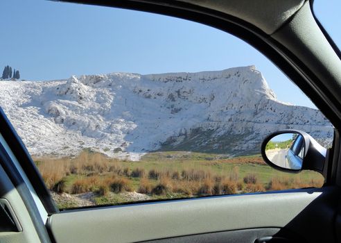 Recording through the window of a car on it sinter clips of Pamukkale, Turkey
