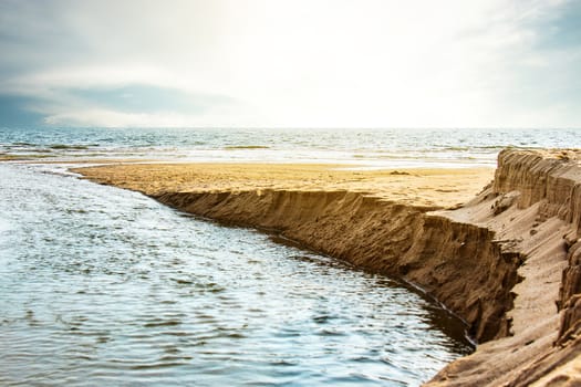 Seashore scene at sunset time. Beautiful seascape. View of the cliffs and the beach. Nature composition