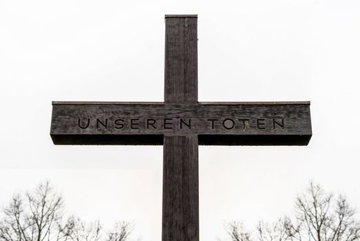 Cross with the inscription "For our dead", behind the castle of Fallersleben, Germany