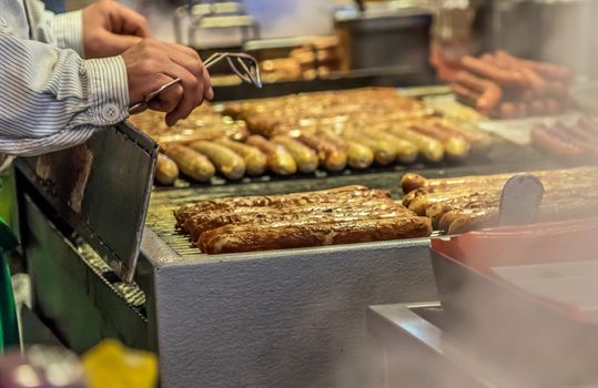 Bratwurst on the grill grid at a booth at the Christmas market in Braunschweig, Germany, detail view