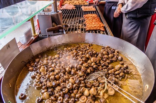 Pan with greasy mushrooms at the Christmas market in Braunschweig, Germany, detail view