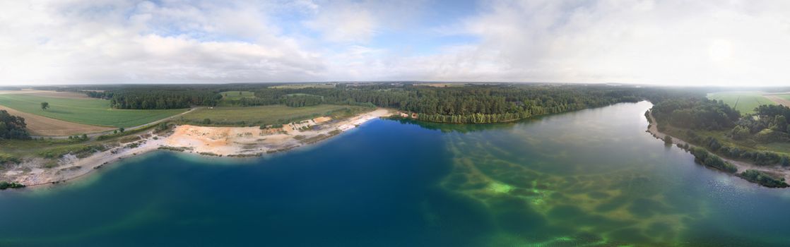 Wide panorama view from aerial photos of a lake in the Lüneburger Heide, composite picture from aerial photos with the drone