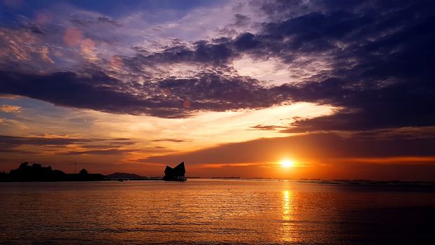 Beautiful colorful twilight radiant sea beach sunset with pavilion background