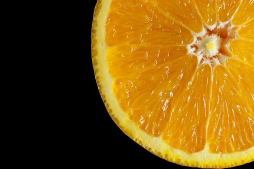 Fresh single orange juice slide background isolate on black background, top view.