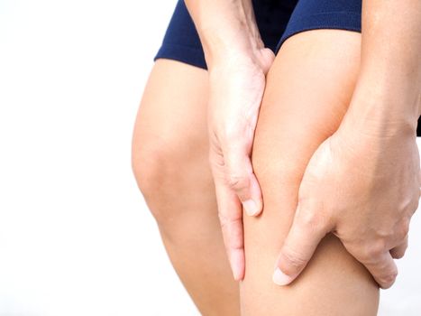 Close-up of Thai Asian body with leg ache and knee pain, isolated on white background.