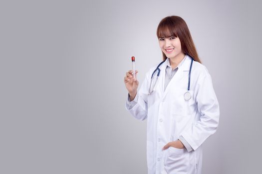 Healthy concept : Young Asian doctor with hypodermic syringe in hand isolate on grey background. Doctor , clinic , hospital poster and advertising with copy space for text