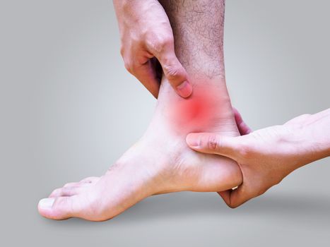 Young man suffering foot and ankle pain or sprained ankle.