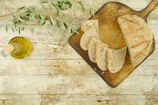 Close-up of a sliced loaf of homemade bread with sesame seeds, a