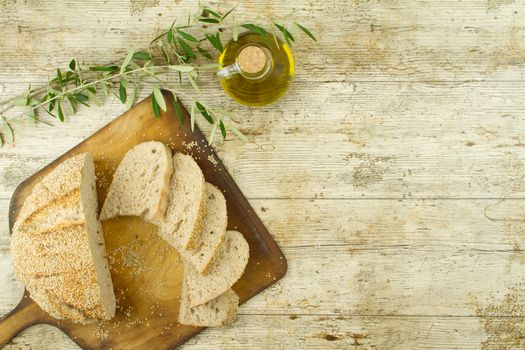 Close-up of a sliced loaf of homemade bread with sesame seeds, a