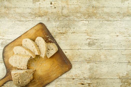 Close-up of a sliced loaf of homemade bread with sesame seeds, a