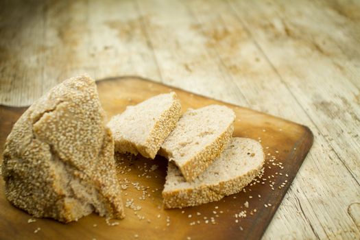 Close-up of a sliced loaf of homemade bread with sesame seeds i