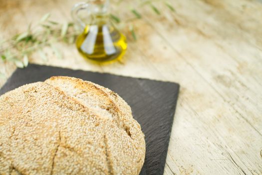 Close-up of a loaf of homemade bread with sesame seeds, ampoule