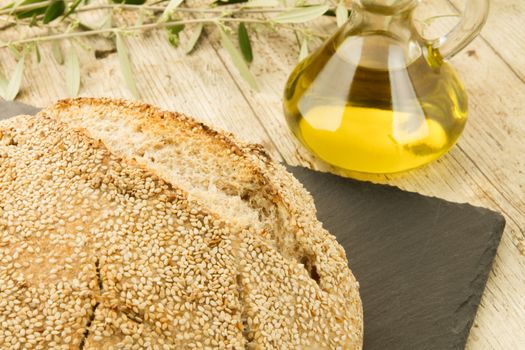 Close-up of a loaf of homemade bread with sesame seeds, ampoule