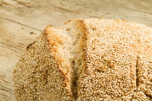 Closeup of a loaf of homemade bread with sesame seeds in selecti