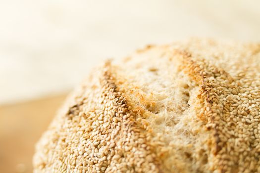 Closeup of a loaf of homemade bread with sesame seeds in selecti