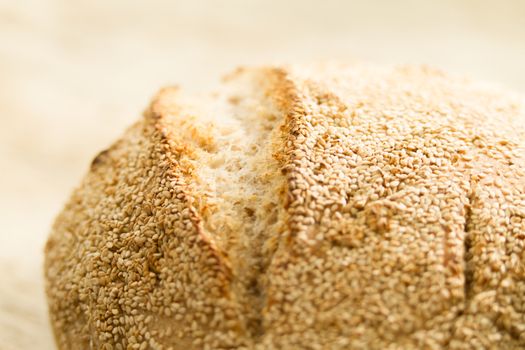 Closeup of a loaf of homemade bread with sesame seeds in selecti