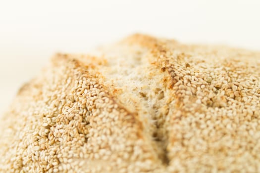 Closeup of a loaf of homemade bread with sesame seeds in selecti