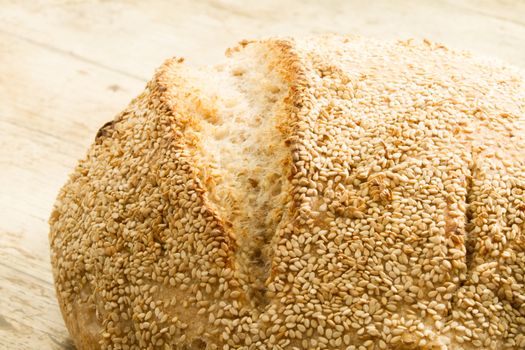 Closeup of a loaf of homemade bread with sesame seeds in selecti