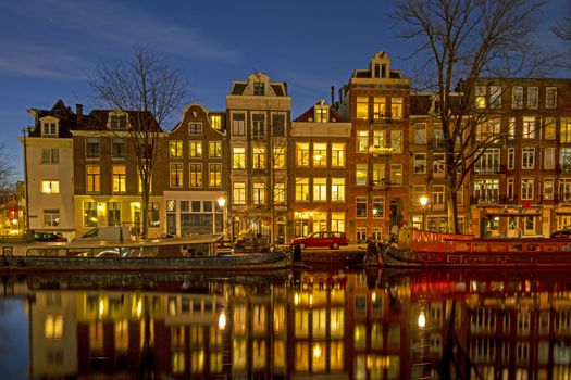 City scenic from Amsterdam at the Amstel in the Netherlands at sunset