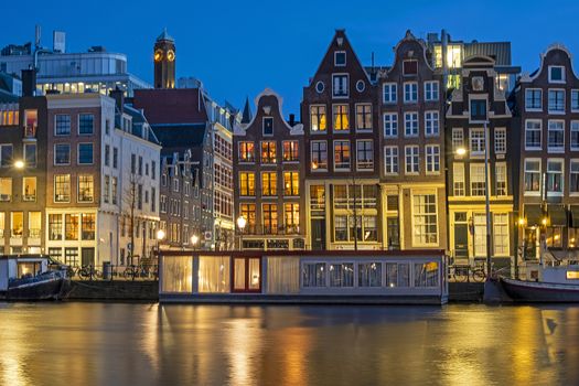 Amsterdam houses and house boats along the Amstel in Amsterdam the Netherlands at sunset